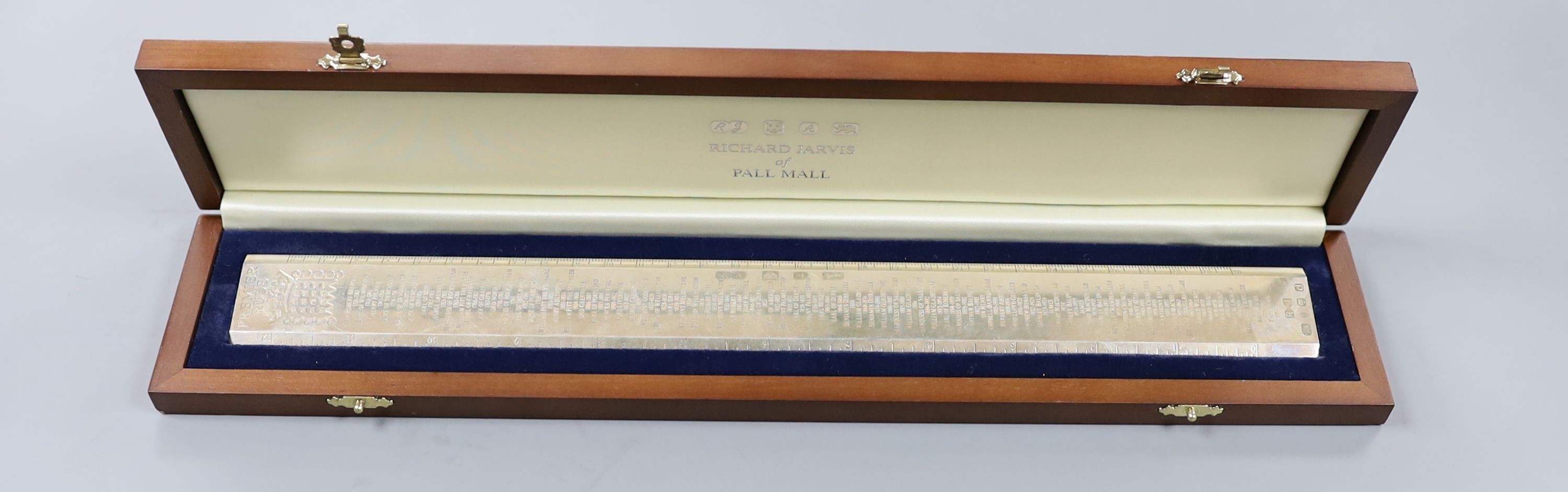 A cased modern silver 'Premier Rule' ruler, engraved with the names and dates of British Prime ministers, by Richard Jarvis, London, 2003, 10oz.